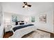 Bright bedroom with white walls, cozy bedding, and natural light from multiple windows at 3015 Pierce St, Wheat Ridge, CO 80214