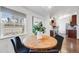 Cozy breakfast nook featuring a round table, black chairs, and natural light from a bright window at 3015 Pierce St, Wheat Ridge, CO 80214