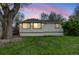 Charming single-story home with well-maintained lawn under a beautiful sunset sky at 3015 Pierce St, Wheat Ridge, CO 80214