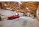 Spacious garage with high ceilings, ample storage, and a classic red car, perfect for car enthusiasts and hobbyists at 3015 Pierce St, Wheat Ridge, CO 80214