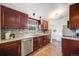 Charming kitchen boasts granite countertops, stainless steel appliances, and warm wood cabinetry at 3015 Pierce St, Wheat Ridge, CO 80214