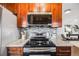 Well-equipped kitchen showcases a sleek cooktop, granite counters, and stylish backsplash at 3015 Pierce St, Wheat Ridge, CO 80214