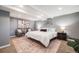 Serene main bedroom with soft lighting, elegant decor, and plush bedding, offering a peaceful retreat for relaxation and rest at 3015 Pierce St, Wheat Ridge, CO 80214