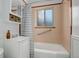Bathroom boasts a tub with shower, vanity, and tiled walls, combining functionality with classic style at 950 Jasmine St, Denver, CO 80220