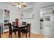 Dining area with hardwood floors, a modern ceiling fan, and adjacent view to the kitchen at 950 Jasmine St, Denver, CO 80220