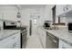 Modern kitchen featuring white cabinets, granite countertops, stainless steel appliances, and a gas range at 950 Jasmine St, Denver, CO 80220