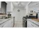 Updated kitchen with white cabinetry, granite countertops and stainless steel appliances at 950 Jasmine St, Denver, CO 80220