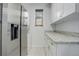 Convenient laundry room features modern appliances, ample counter space, and stylish cabinetry at 950 Jasmine St, Denver, CO 80220