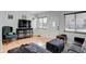 Bright living room with light hardwood floors, large windows and comfortable furniture at 950 Jasmine St, Denver, CO 80220