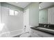 Clean bathroom featuring subway tile in the shower and a modern vanity with ample counter space at 5455 E Iowa Ave, Denver, CO 80222