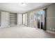 Bedroom with carpet, large windows, and built-in shelves, offering comfort and convenience at 5455 E Iowa Ave, Denver, CO 80222