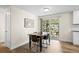 Dining room featuring wood floors and access to the patio through a sliding glass door at 5455 E Iowa Ave, Denver, CO 80222