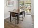 Dining room with wood-look flooring and a sliding glass door to the backyard at 5455 E Iowa Ave, Denver, CO 80222