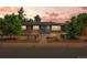 Charming brick home featuring a landscaped front yard, solar panels, and blue door at 5455 E Iowa Ave, Denver, CO 80222