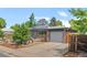Charming single-story home with a well-manicured lawn and an attached garage at 5455 E Iowa Ave, Denver, CO 80222