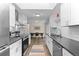 Contemporary kitchen featuring white cabinets, stainless steel appliances, and eat-in dining at 5455 E Iowa Ave, Denver, CO 80222