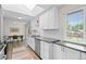 Bright kitchen with modern appliances, subway tile backsplash and eat in kitchen at 5455 E Iowa Ave, Denver, CO 80222