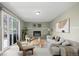 Cozy living room with a fireplace, neutral tones, and sliding glass doors at 5455 E Iowa Ave, Denver, CO 80222