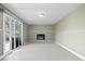 Spacious living room with fireplace and sliding glass doors leading to the outdoor area at 5455 E Iowa Ave, Denver, CO 80222