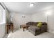 Cozy living room featuring a sectional sofa with a large screen television for relaxing evenings at 5455 E Iowa Ave, Denver, CO 80222