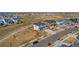 Areal view of a neighborhood with modern homes, green spaces and mountain views on a sunny day at 806 Flora View Dr, Erie, CO 80516