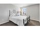 Bright bedroom with a decorative bed frame and a large window at 806 Flora View Dr, Erie, CO 80516
