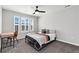 Cozy bedroom with a large window, plush carpeting, and a modern ceiling fan at 806 Flora View Dr, Erie, CO 80516