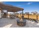 Outdoor backyard area with a fire pit, patio, pergola, and neighborhood view at 806 Flora View Dr, Erie, CO 80516