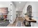 An inviting foyer with an ornate decoration and wooden floors that lead to a bright living space at 806 Flora View Dr, Erie, CO 80516