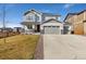Inviting two-story home with a well-maintained lawn and a three-car garage at 806 Flora View Dr, Erie, CO 80516