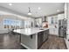 Bright kitchen features a large island, stainless steel appliances, and wood floors at 806 Flora View Dr, Erie, CO 80516