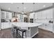 Spacious kitchen with a large island, pendant lighting, and modern appliances at 806 Flora View Dr, Erie, CO 80516