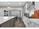 Eat-in kitchen features an island with seating and modern appliances at 806 Flora View Dr, Erie, CO 80516