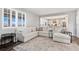 Open concept living room with a spacious sofa and view of the modern kitchen with an island at 806 Flora View Dr, Erie, CO 80516