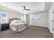 Tranquil main bedroom with tray ceilings, a ceiling fan, and natural light at 806 Flora View Dr, Erie, CO 80516