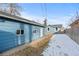 Backyard view of detached garage, seating area, and home at 131 S Grove St, Denver, CO 80219