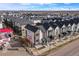 Aerial shot of modern townhouses with nearby gas station and city skyline view in a desirable location at 5188 Ward Rd, Wheat Ridge, CO 80033