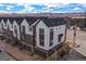 Aerial view of modern townhouses with mountain views and attached garages in a well-kept neighborhood at 5188 Ward Rd, Wheat Ridge, CO 80033