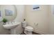 Powder room features modern fixtures, a pedestal sink, and stylish decor at 5188 Ward Rd, Wheat Ridge, CO 80033