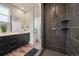 Modern bathroom boasts dual sinks, sleek fixtures, and a beautifully tiled, glass-enclosed shower at 5188 Ward Rd, Wheat Ridge, CO 80033