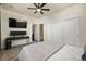 Comfortable bedroom features neutral walls, a ceiling fan, and closet with sliding doors at 5188 Ward Rd, Wheat Ridge, CO 80033