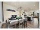Dining area with hardwood floors, modern lighting, with view of kitchen and living area at 5188 Ward Rd, Wheat Ridge, CO 80033