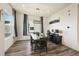 Dining area with wood floors, modern lighting, and a view to the exterior at 5188 Ward Rd, Wheat Ridge, CO 80033