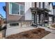 Townhome exterior showing brick accents, landscaped yard, and a modern front porch at 5188 Ward Rd, Wheat Ridge, CO 80033