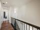 Upstairs hallway with hardwood floors and dark metal railing at 5188 Ward Rd, Wheat Ridge, CO 80033