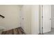 Hallway featuring hardwood-style floors, white walls and trim, and several doors at 5188 Ward Rd, Wheat Ridge, CO 80033