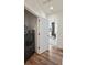 Bright laundry room features wood-look floors and modern black stainless steel washer and dryer at 5188 Ward Rd, Wheat Ridge, CO 80033