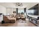 Open concept living room featuring hardwood floors, a ceiling fan, and a large window at 5188 Ward Rd, Wheat Ridge, CO 80033