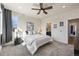 Bright main bedroom with large windows, ceiling fan, and carpeted flooring at 5188 Ward Rd, Wheat Ridge, CO 80033