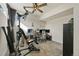 Bright office area featuring modern ceiling fan, home gym, and desk setup at 5188 Ward Rd, Wheat Ridge, CO 80033